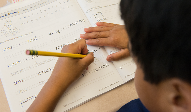 Student practicing cursive writing